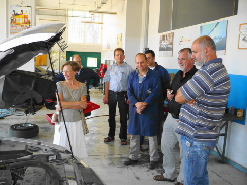 Ambassador looking at pick-up truck donated by GIZ